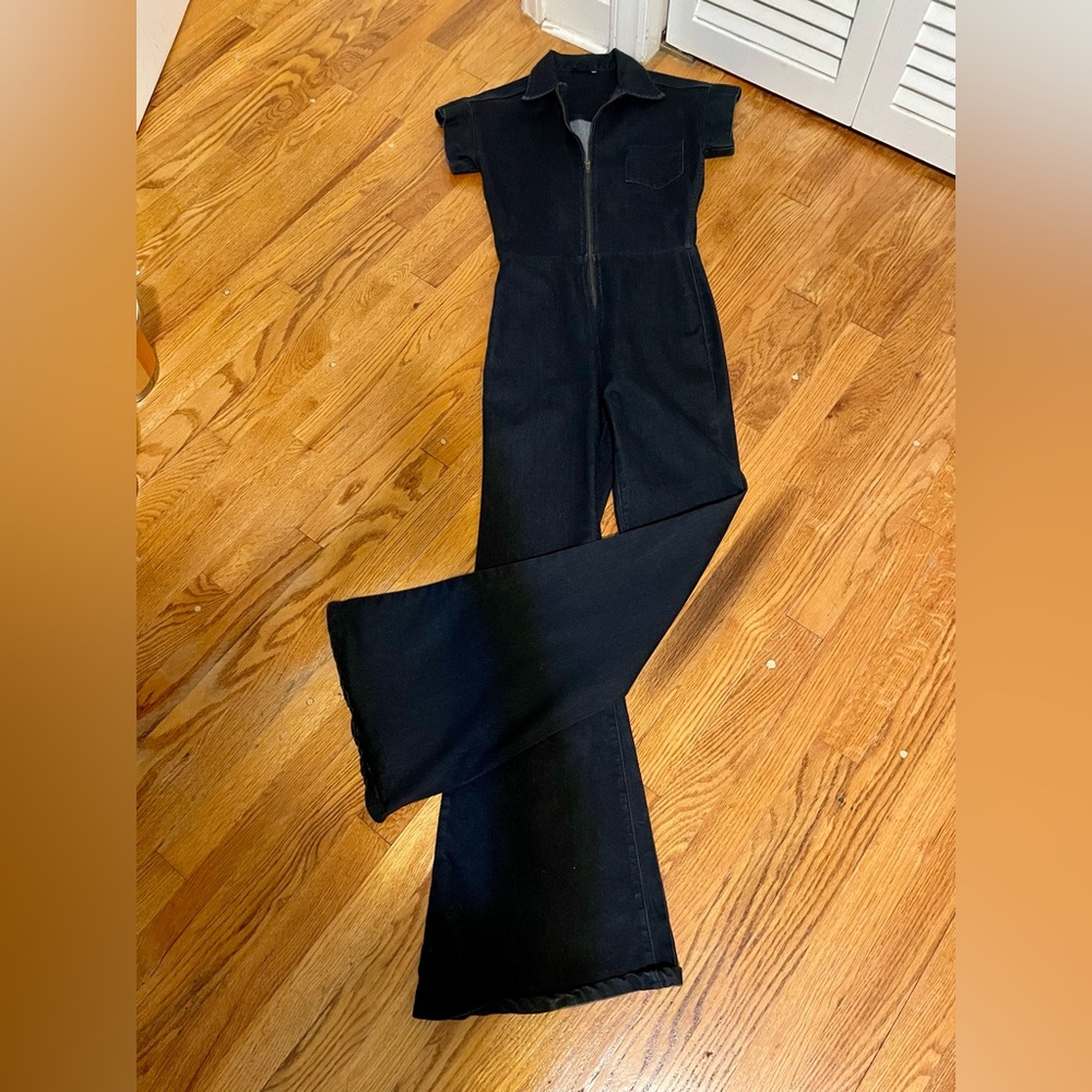 Stretchy and very flattering dark denim jumpsuit. Gorgeous wide flare legs!